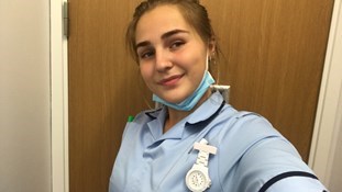 Nurse takes a selfie wearing personal protective equipment