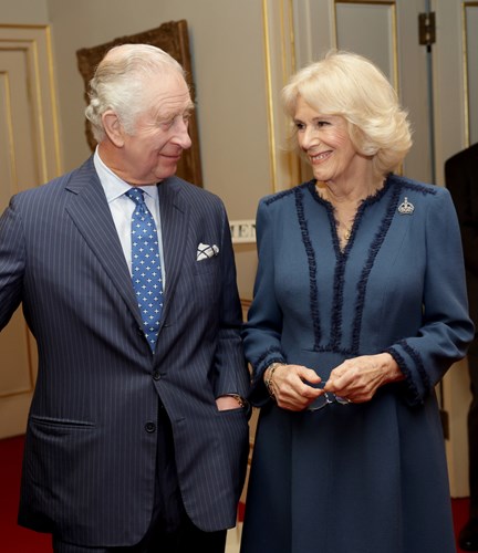 King Charles and Queen Camilla standing in a room